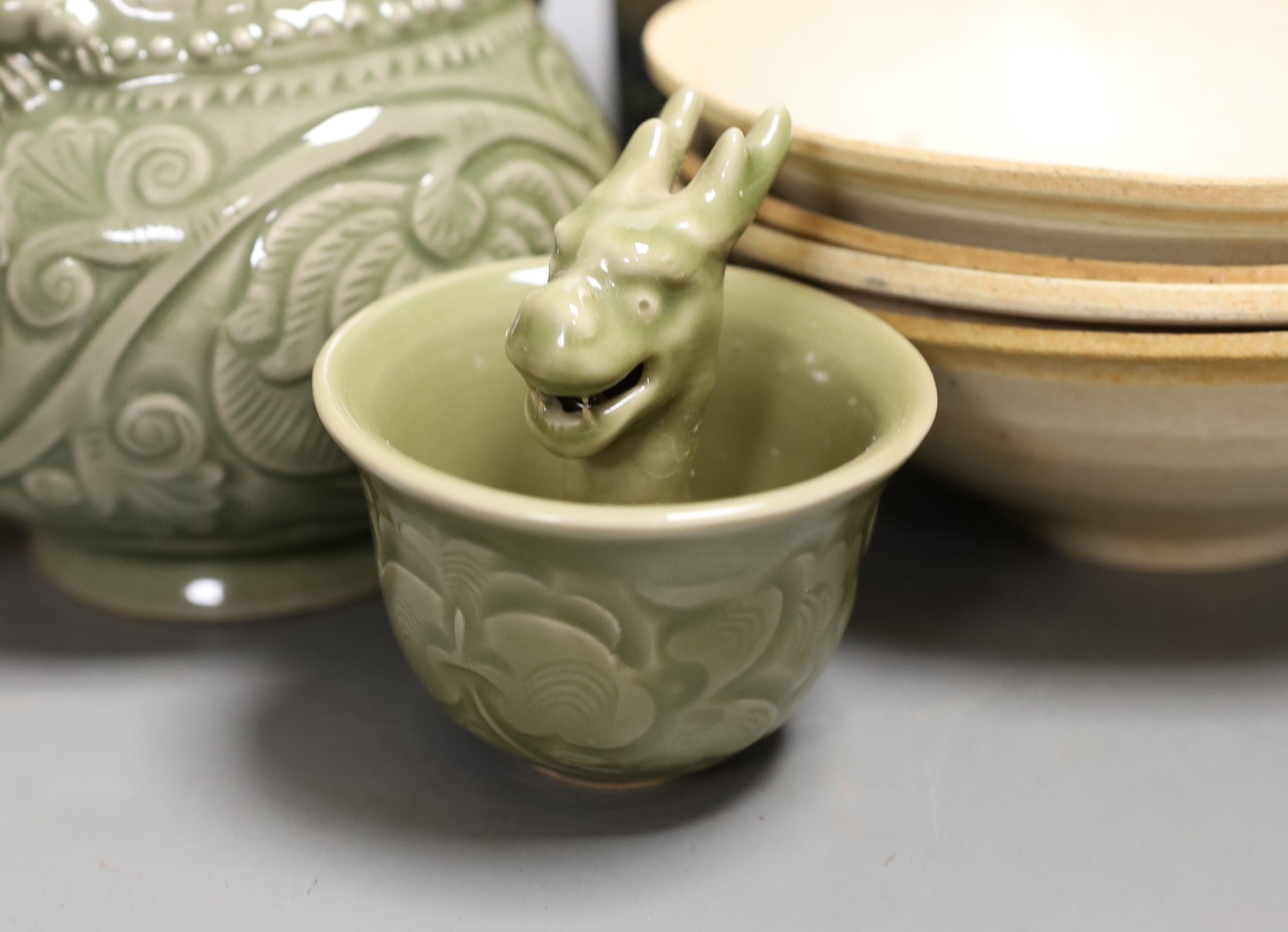 A group of Chinese celadon vessels and Qingbai type bowls, teapot 17 cms high.